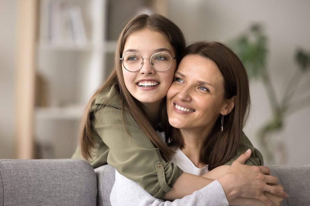A mother and daughter share a happy moment with bright smiles, symbolizing lasting oral health and family confidence – Root Canal Cerritos.